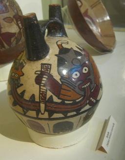 Ceramic bottle of Nazca
                                    culture, the god has got a knife in
                                    his hand